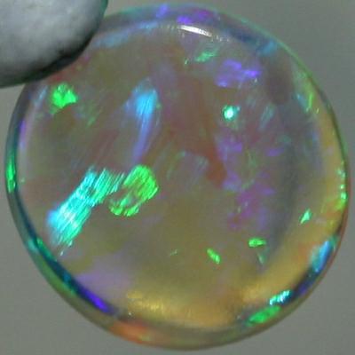 SOLID CRYSTAL OPAL Sparkles of green show in a Chaff pattern, totally clean body.